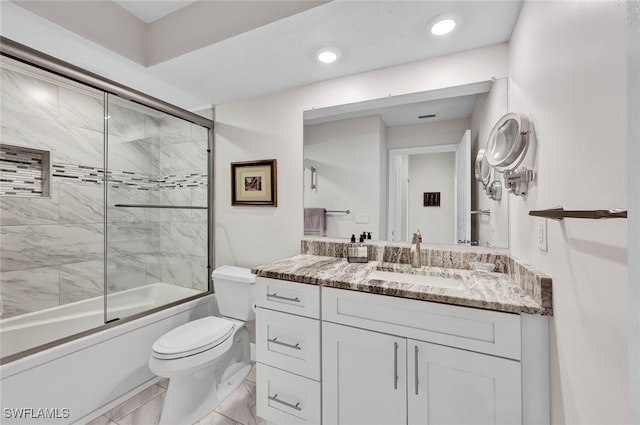 bathroom with recessed lighting, combined bath / shower with glass door, vanity, and toilet