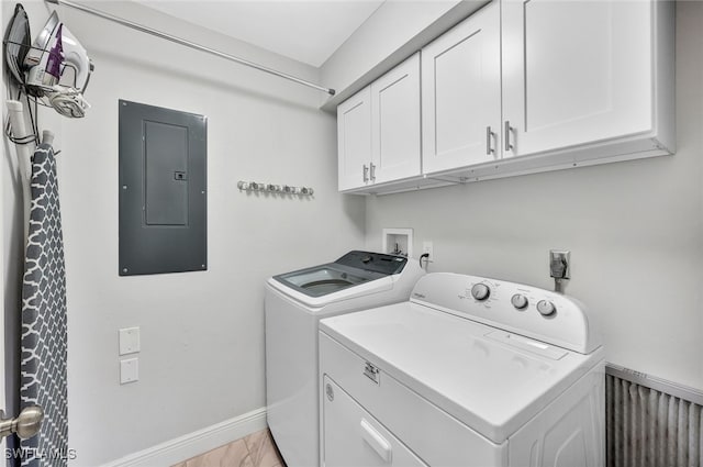 washroom with washer and clothes dryer, cabinet space, electric panel, and baseboards