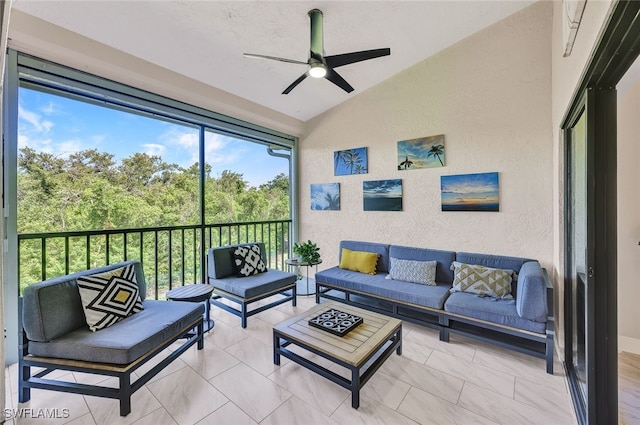 sunroom with ceiling fan and lofted ceiling