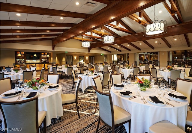 dining area with lofted ceiling with beams