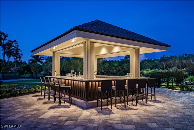 view of patio with outdoor dry bar and a gazebo