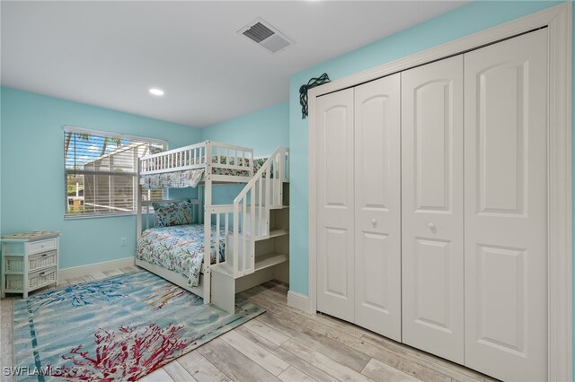 bedroom with a closet and light hardwood / wood-style floors