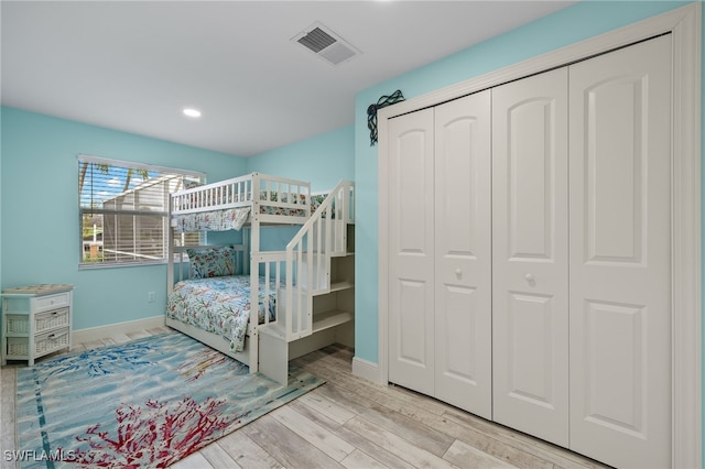 bedroom with visible vents, wood finished floors, recessed lighting, a closet, and baseboards