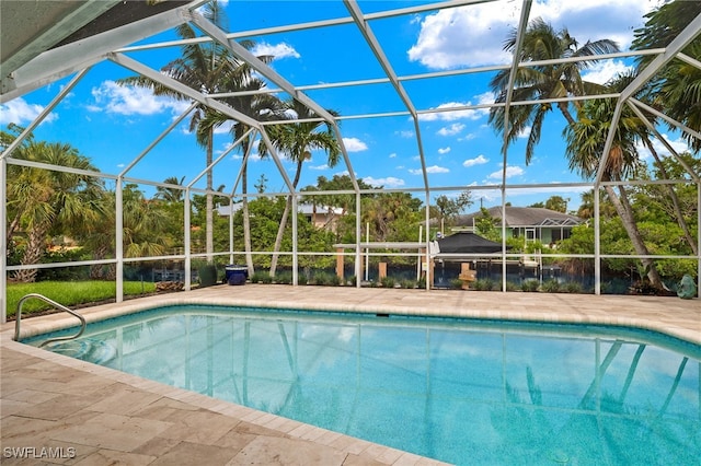 view of pool featuring glass enclosure