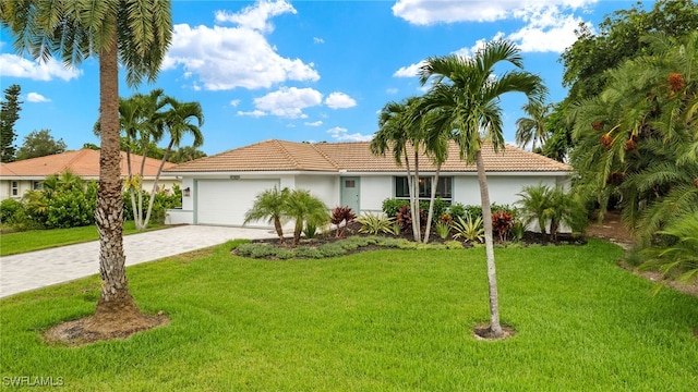 view of front facade with decorative driveway, a front lawn, an attached garage, and stucco siding