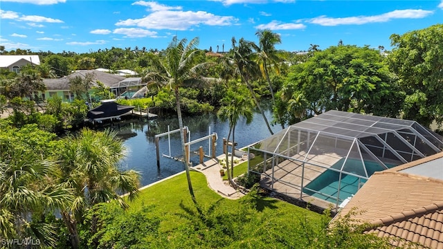 dock area featuring glass enclosure, a patio, a yard, an outdoor pool, and a water view