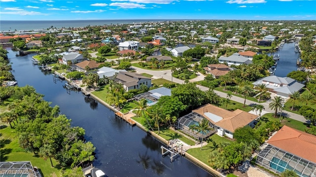 birds eye view of property featuring a water view and a residential view