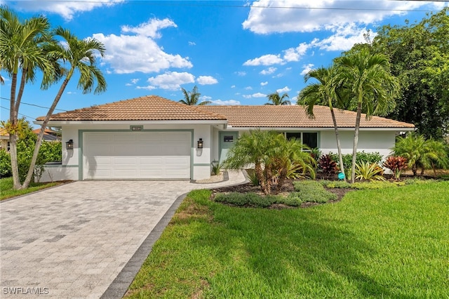 view of front of house with a garage and a front lawn