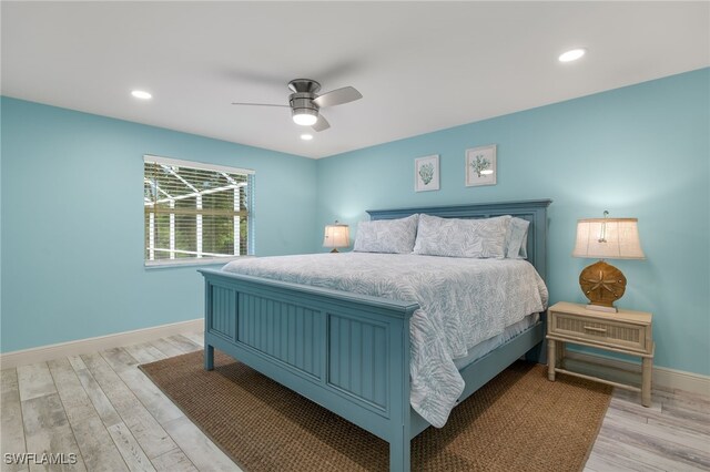 bedroom with ceiling fan and light hardwood / wood-style floors