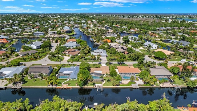 drone / aerial view featuring a residential view and a water view