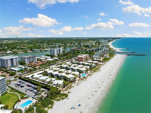 drone / aerial view featuring a water view and a beach view