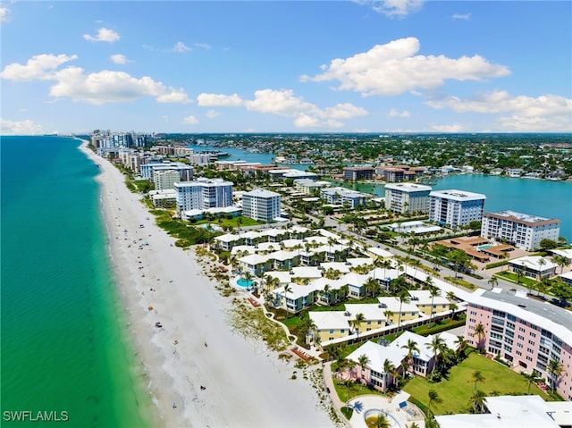 birds eye view of property with a beach view and a water view