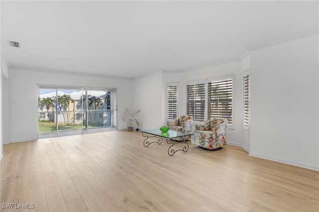 unfurnished room with light hardwood / wood-style floors, a wealth of natural light, and ornamental molding