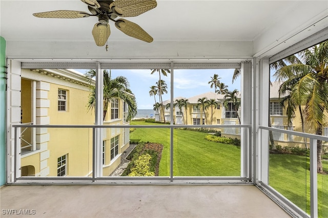 unfurnished sunroom featuring ceiling fan