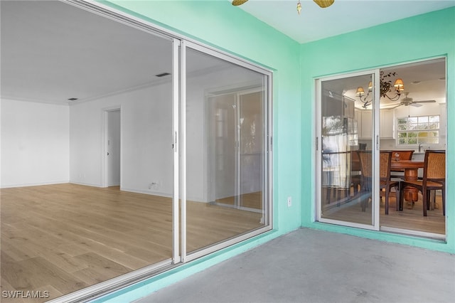 unfurnished sunroom with ceiling fan