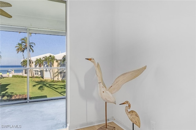 interior space with plenty of natural light and a water view