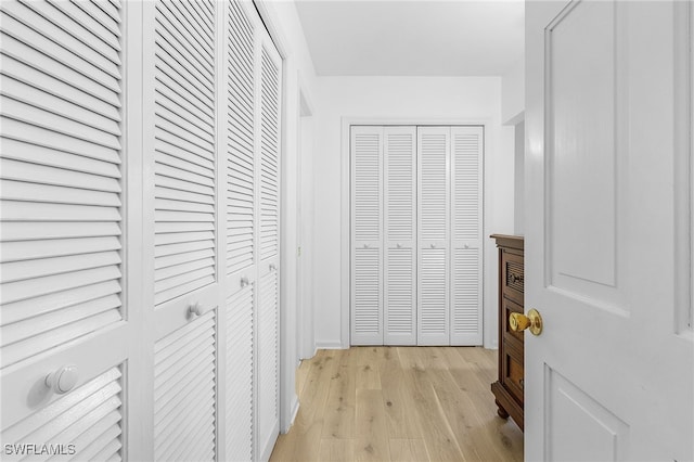 hallway with light hardwood / wood-style floors