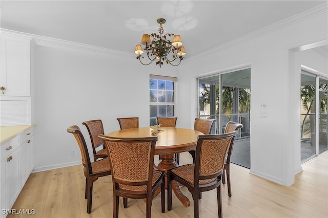 dining area featuring crown molding, a chandelier, and light wood-type flooring