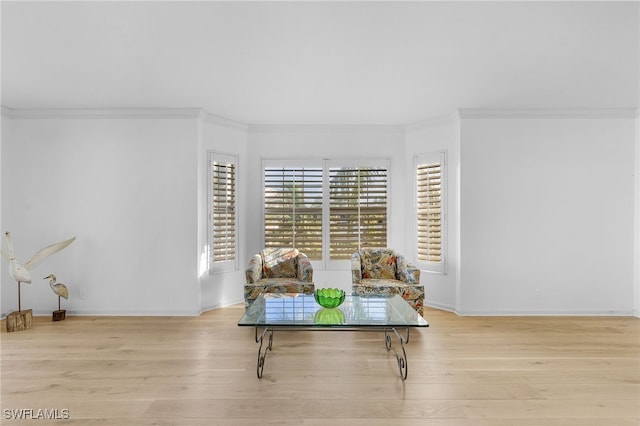 sitting room featuring light hardwood / wood-style flooring and ornamental molding