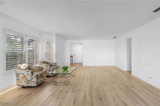 living room with light hardwood / wood-style flooring and ornamental molding