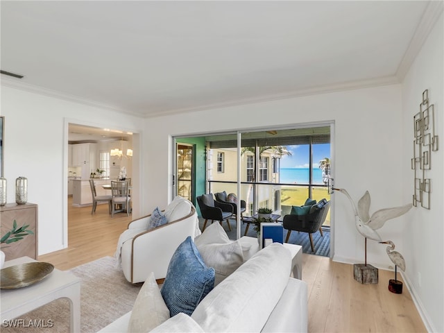 2601 Gulf Shore Blvd N Unit 34, Naples, FL 34103 - living room featuring wood finished floors, a chandelier, and crown molding