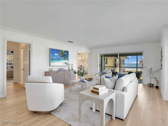 2601 Gulf Shore Blvd N Unit 34, Naples, FL 34103 - living room featuring crown molding and light wood finished floors