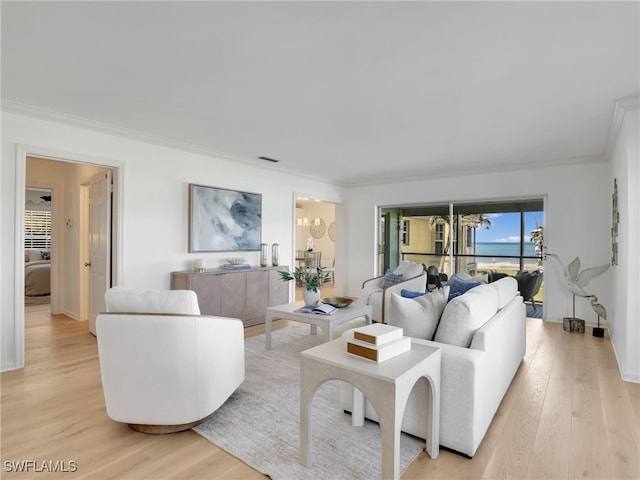 2601 Gulf Shore Blvd N Unit 34, Naples, FL 34103 - living room featuring light wood-type flooring and crown molding
