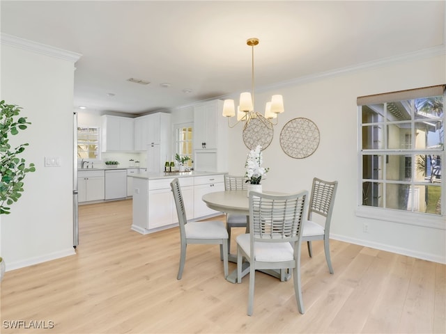 2601 Gulf Shore Blvd N Unit 34, Naples, FL 34103 - dining room with a chandelier, ornamental molding, and light wood finished floors
