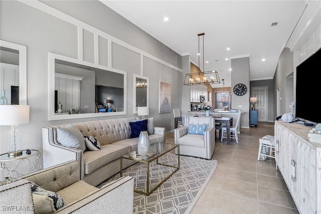 tiled living room with an inviting chandelier and ornamental molding