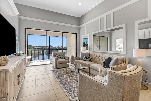 living area featuring a high ceiling, light tile patterned floors, and ornamental molding