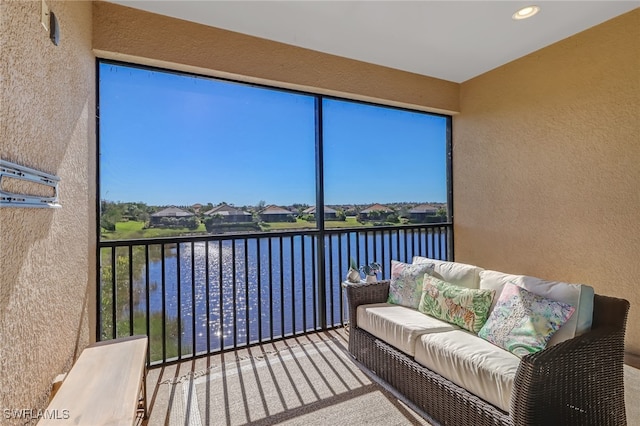 sunroom / solarium with a water view