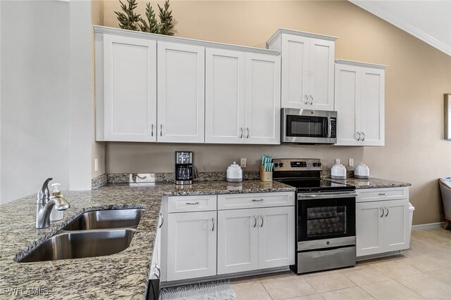 kitchen featuring sink, light tile patterned floors, crown molding, white cabinetry, and stainless steel appliances