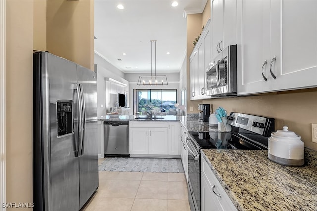 kitchen with light tile patterned flooring, stone countertops, stainless steel appliances, kitchen peninsula, and white cabinets