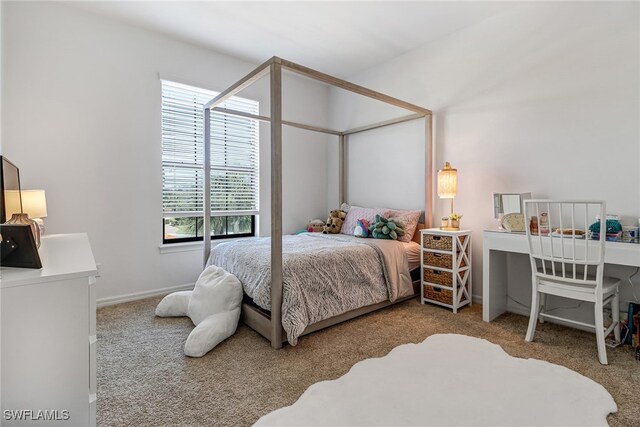 bedroom featuring light carpet