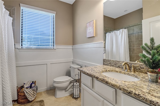 bathroom with tile patterned flooring, toilet, vanity, and a shower with curtain