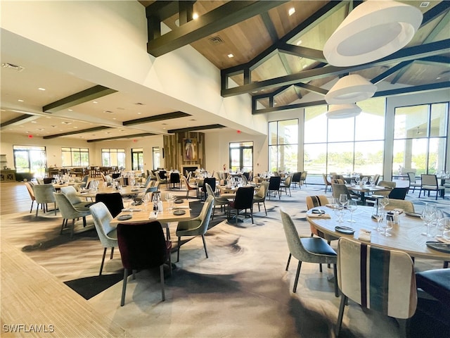 dining room featuring beamed ceiling and high vaulted ceiling