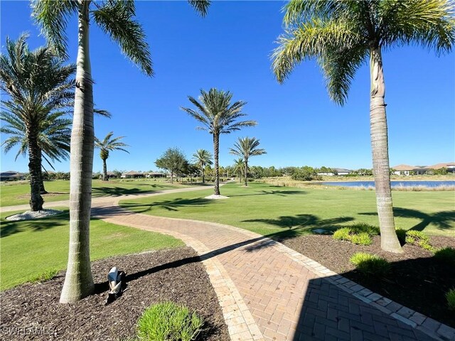 view of community featuring a water view and a lawn