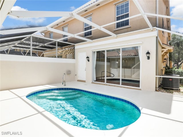 view of swimming pool with a patio, central AC, and a lanai