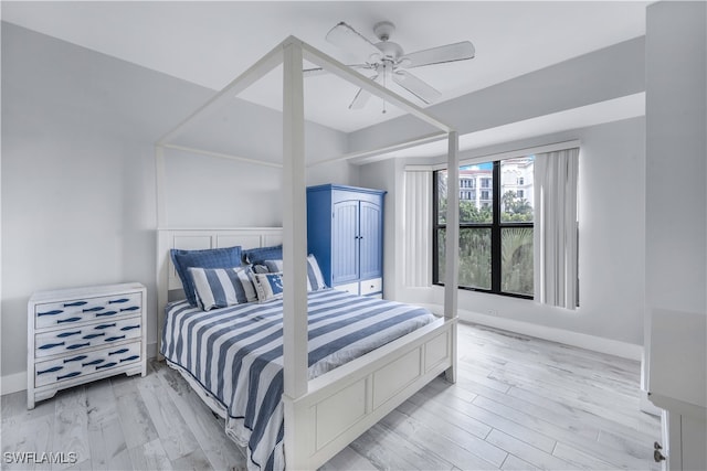 bedroom with light wood-type flooring and ceiling fan