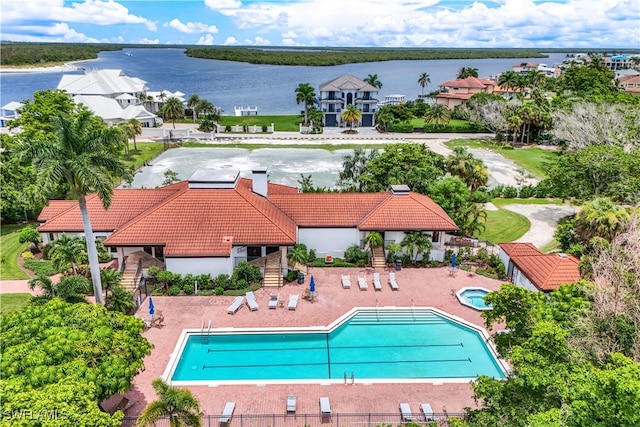 view of pool featuring a water view and a patio area