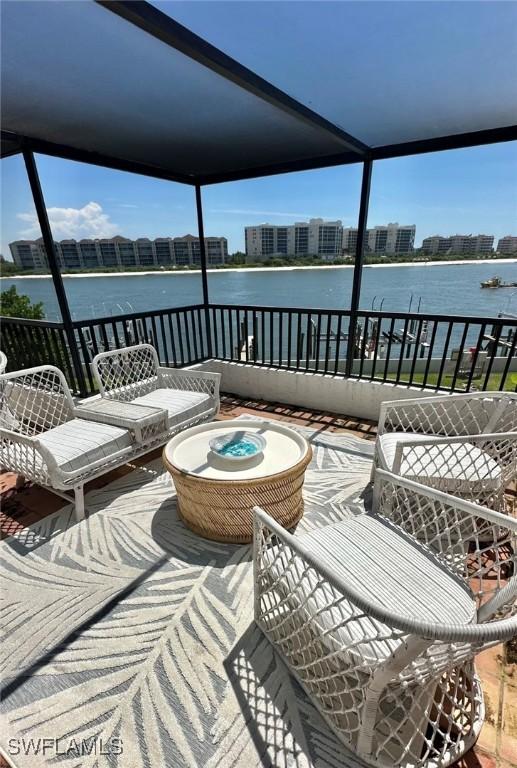 view of patio / terrace featuring a balcony and a water view