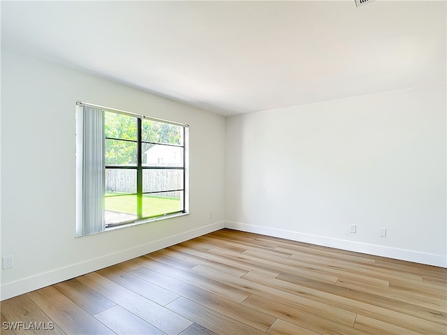 spare room featuring light hardwood / wood-style floors