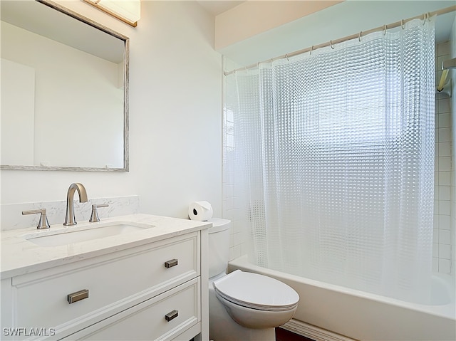 full bathroom with vanity, shower / tub combo, and toilet