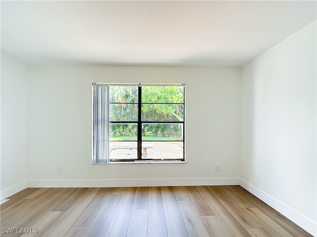 unfurnished room with plenty of natural light and light hardwood / wood-style floors