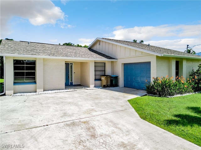 single story home featuring a garage and a front lawn