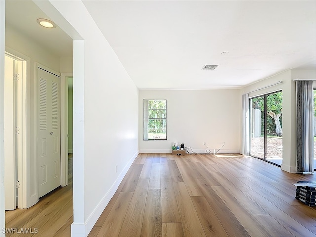 unfurnished room with light hardwood / wood-style flooring and a healthy amount of sunlight