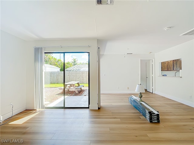 exercise room featuring light hardwood / wood-style flooring