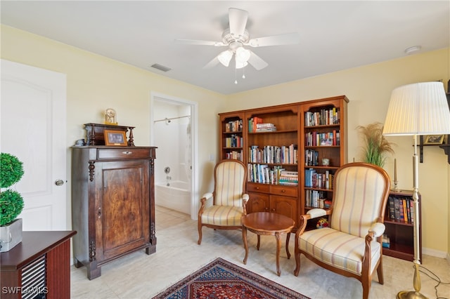 sitting room featuring ceiling fan