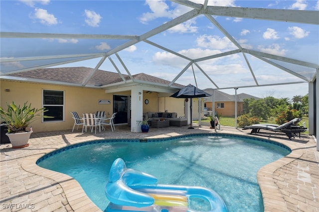 view of pool featuring a lanai, a patio, outdoor lounge area, and pool water feature