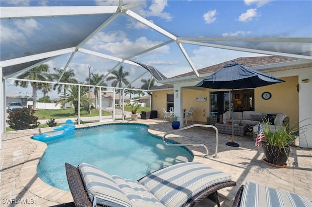 view of swimming pool featuring glass enclosure, outdoor lounge area, and a patio area